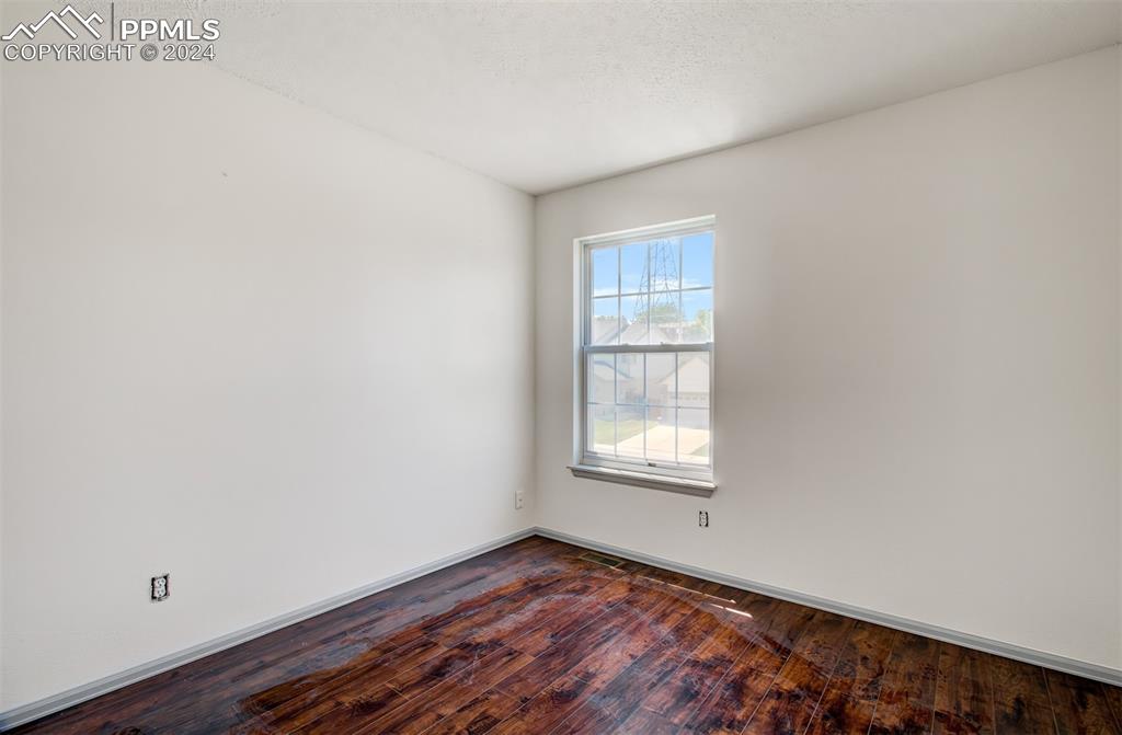 4176 South Himalaya Way Aurora, CO 80013 - Photo 18 of 27 Spare room featuring hardwood / wood-style flooring