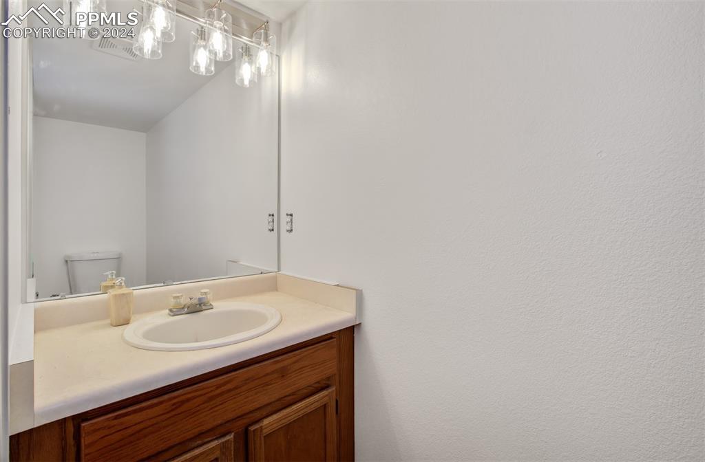 4176 South Himalaya Way Aurora, CO 80013 - Photo 22 of 27 Bathroom with vanity and toilet