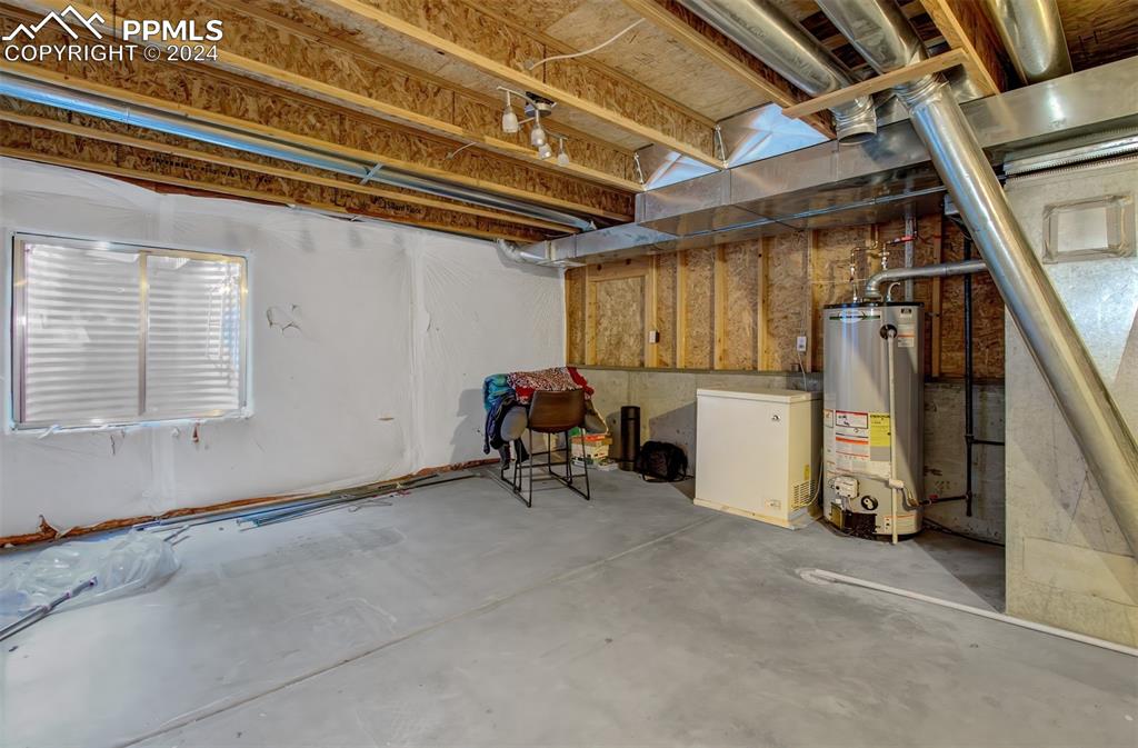 4176 South Himalaya Way Aurora, CO 80013 - Photo 24 of 27 Basement featuring water heater