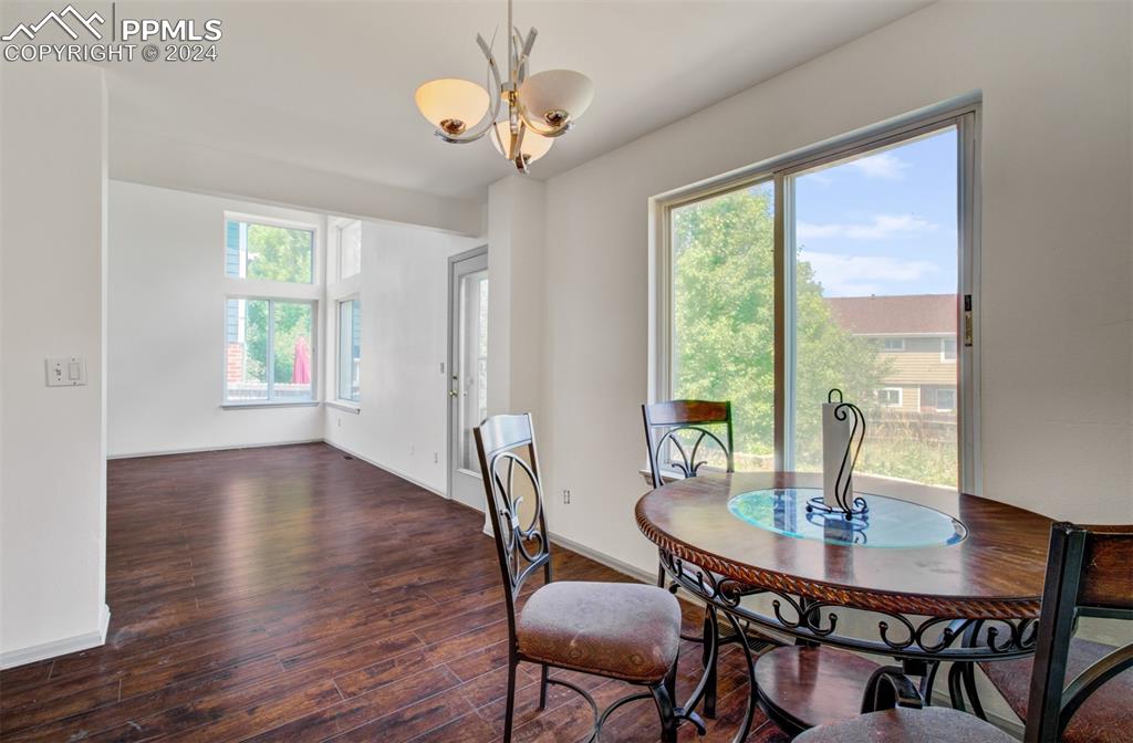 4176 South Himalaya Way Aurora, CO 80013 - Photo 8 of 27 Dining space with a notable chandelier and dark hardwood / wood-style floors