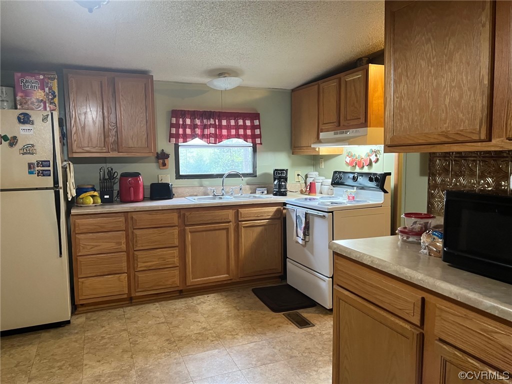 1092 Saunders Lane Meherrin, VA 23954 - Photo 8 of 19 a kitchen with cabinets appliances a sink and a counter top space