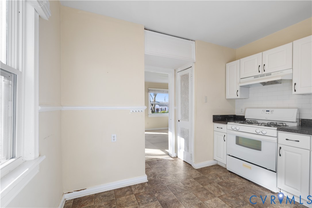 3423 Reynolds Road Richmond, VA 23223 - Photo 11 of 26 a kitchen with white cabinets and white appliances