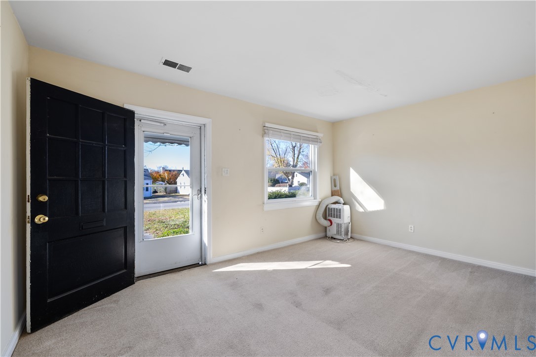 3423 Reynolds Road Richmond, VA 23223 - Photo 5 of 26 an empty room with windows and closet