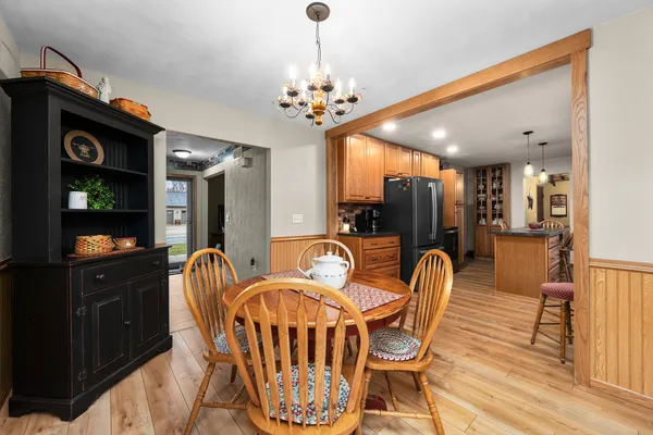 a dining room with furniture a chandelier and window
