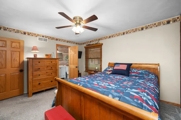 a bedroom with a bed and a chandelier