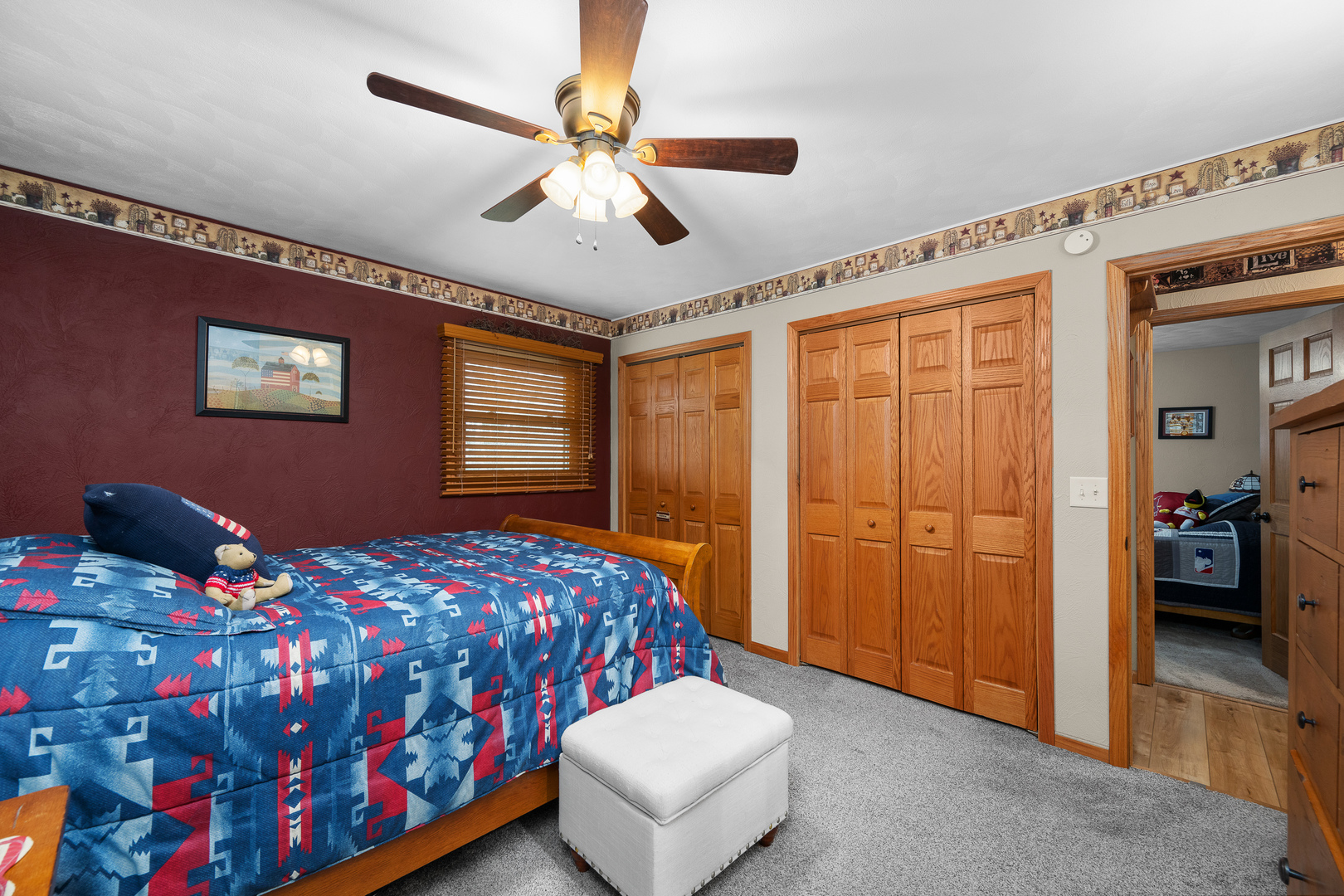 10 Pine Tree Court Kewanee, IL 61443 - Photo 21 of 39 a bedroom with a bed and a chandelier