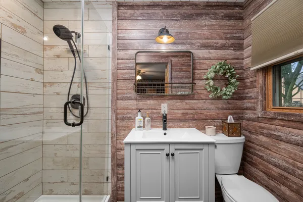 a bathroom with a sink toilet and shower