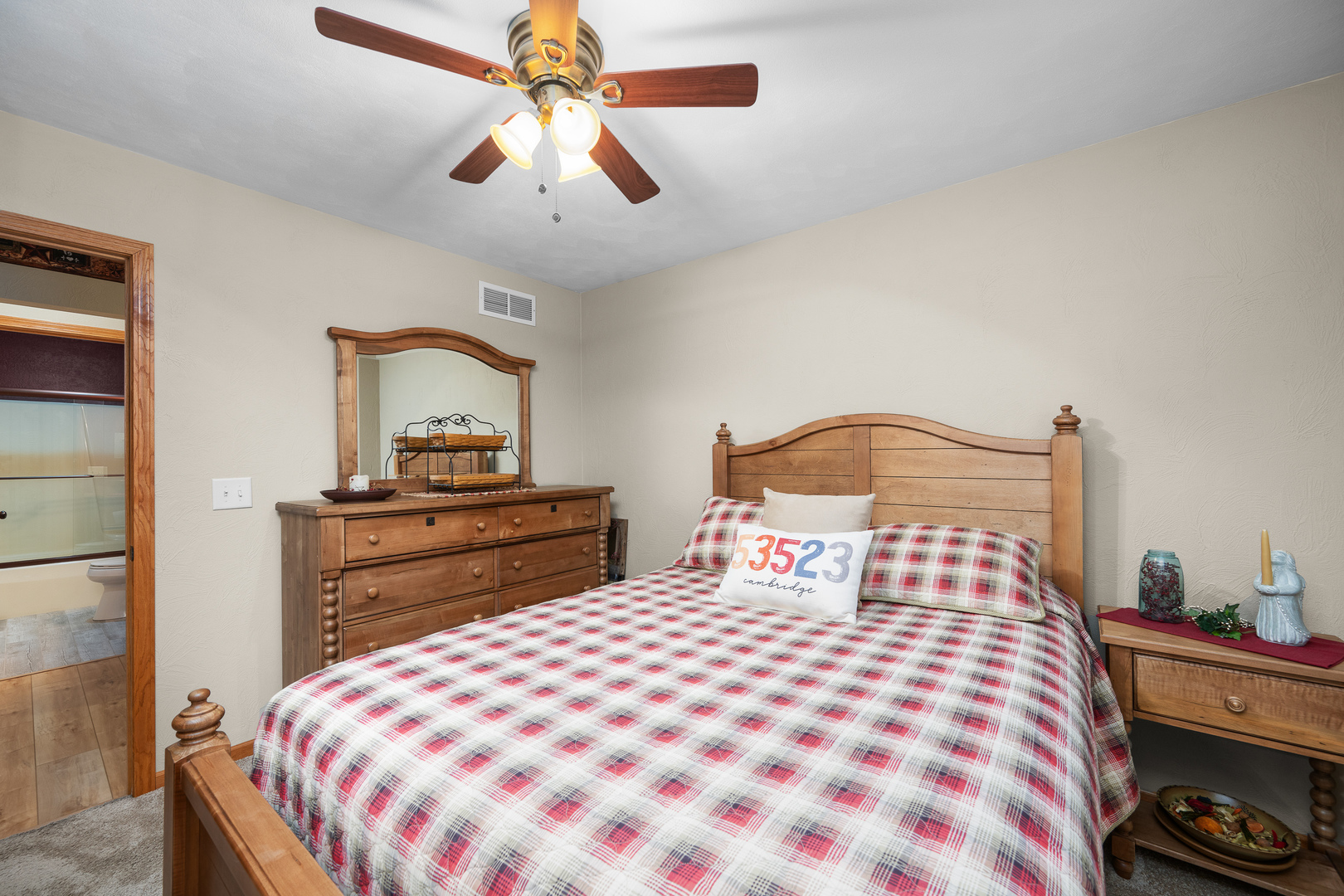 10 Pine Tree Court Kewanee, IL 61443 - Photo 24 of 39 a bedroom with a bed and a chandelier