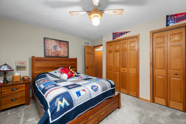 a bedroom with a bed and a chandelier