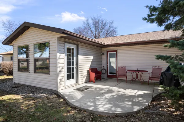 a view of a house with a patio and a yard