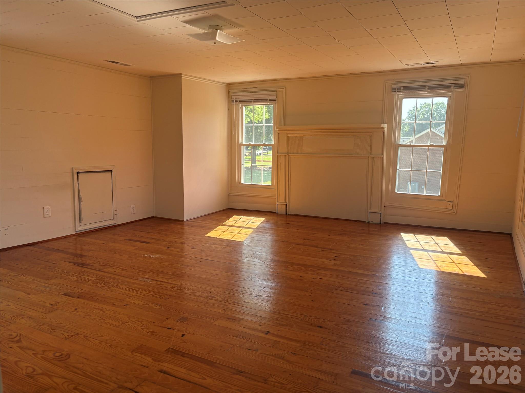 6625 Long Road Matthews, NC 28104 - Photo 16 of 21 an empty room with wooden floor and windows