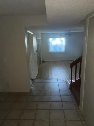 a view of an empty room with stairs