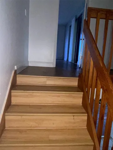 a view of a livingroom with wooden floor and window