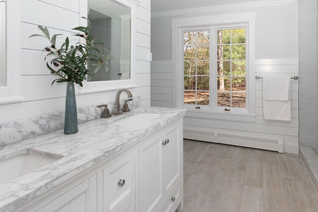 3 Kalmia Way Barnstable, MA 02632 - Photo 16 of 26 a bathroom with a granite countertop sink a large mirror a bathtub and next to a window