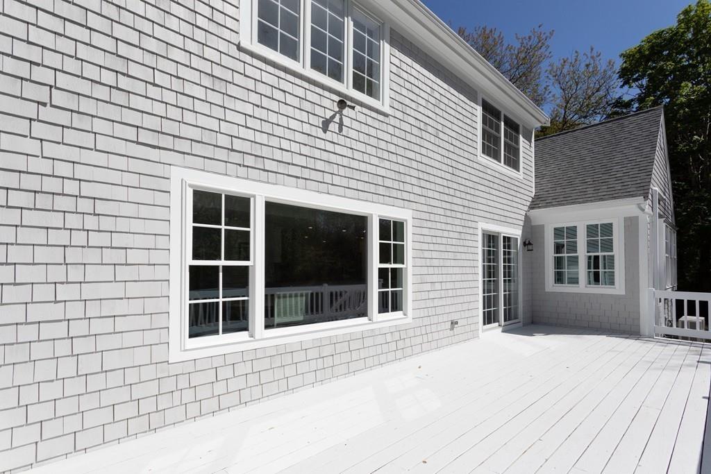 3 Kalmia Way Barnstable, MA 02632 - Photo 4 of 26 a front view of a house with a yard and garage