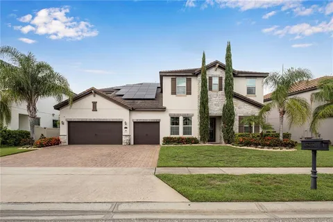 a front view of a house with a garden and plants