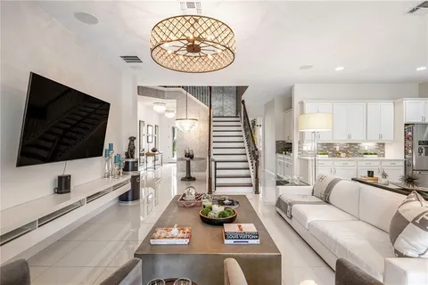 a view of a kitchen with kitchen island a sink stainless steel appliances and a counter top space