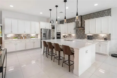 a kitchen with stainless steel appliances granite countertop a sink and cabinets