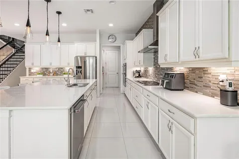 a view of a dining room with furniture and a potted plant