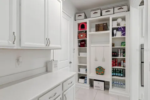a living room with furniture a window and a chandelier