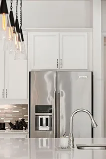 a view of a kitchen with wooden floor and cabinets