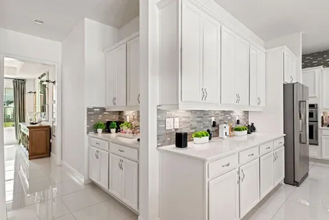 an open kitchen with stainless steel appliances granite countertop a stove center island a dining table and chairs with wooden floor