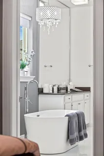 a living room with furniture kitchen view and a window