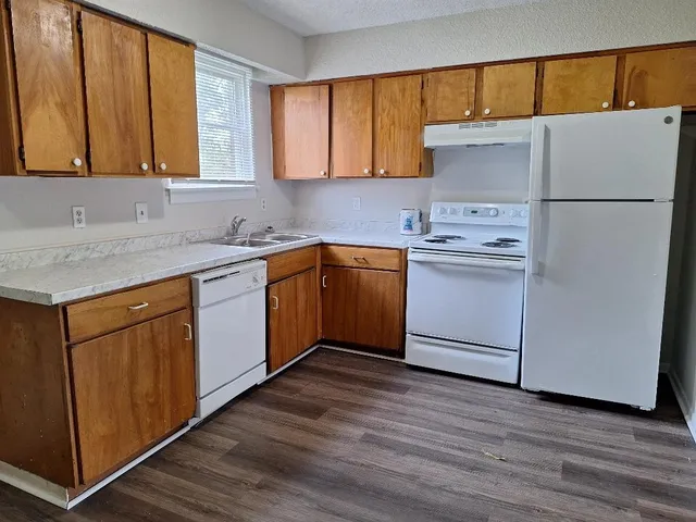 a kitchen with appliances cabinets and a sink