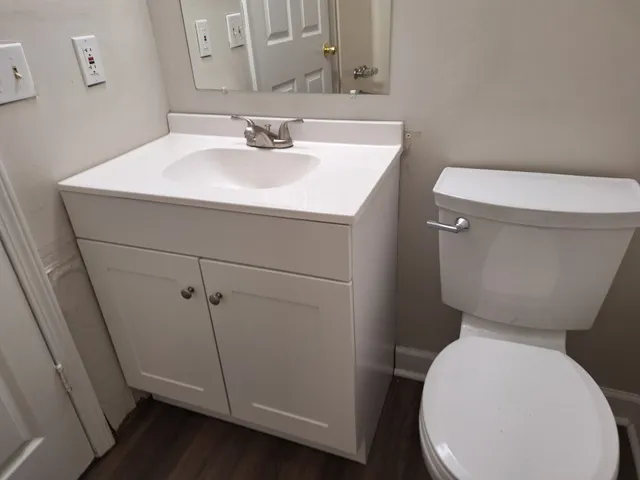 a white toilet sitting next to a bathroom sink