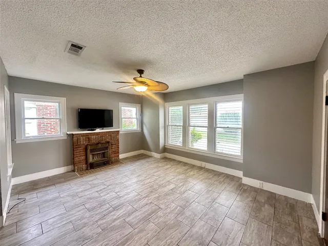 a view of a livingroom with furniture window and wooden floor