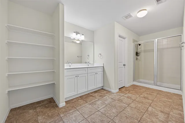 a bathroom with a sink vanity and a mirror