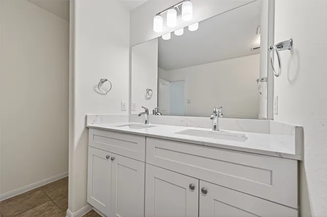 a bathroom with a double vanity sink a mirror and shower