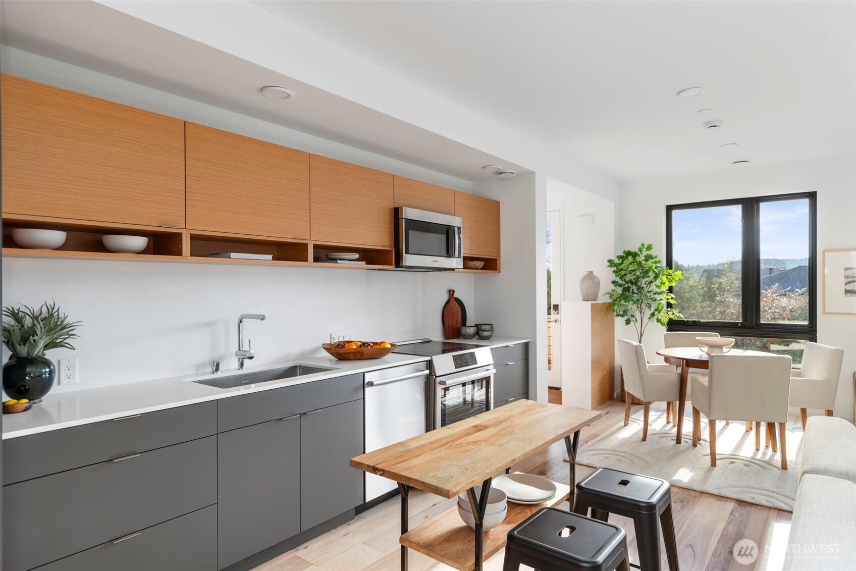 212 Shepard Way Northwest Bainbridge Island, WA 98110 - Photo 7 of 29 a kitchen with stainless steel appliances granite countertop a sink a stove a dining table and chairs