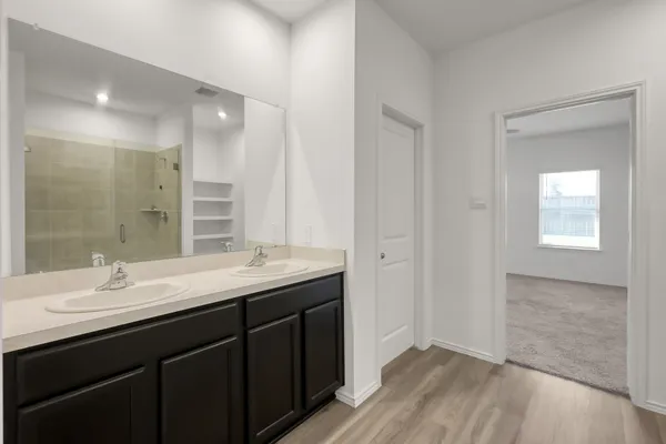 a bathroom with a double vanity sink and a mirror