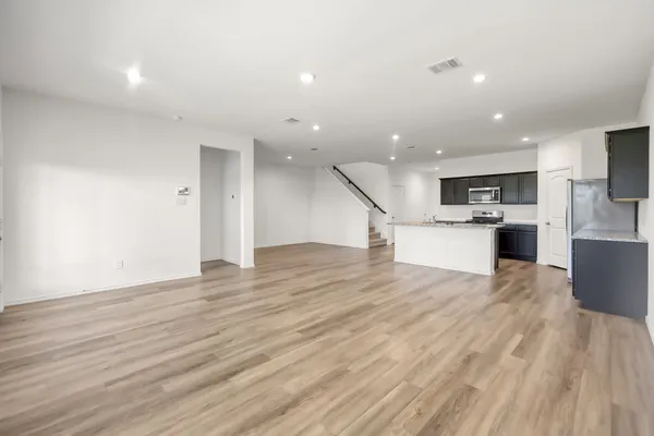 a view of kitchen with cabinets and wooden floor