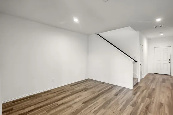 a view of hallway with wooden floor
