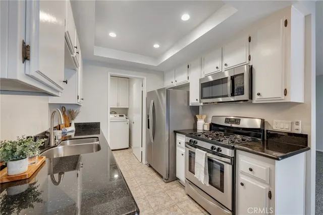 a kitchen with refrigerator cabinets and furniture