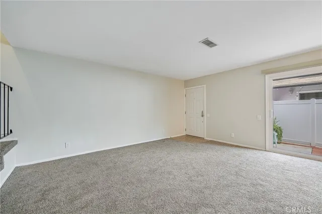 a view of staircase with lots of frames on wall and wooden floor