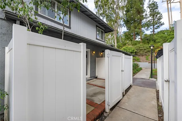 a view of a patio with a table and chairs and potted plants