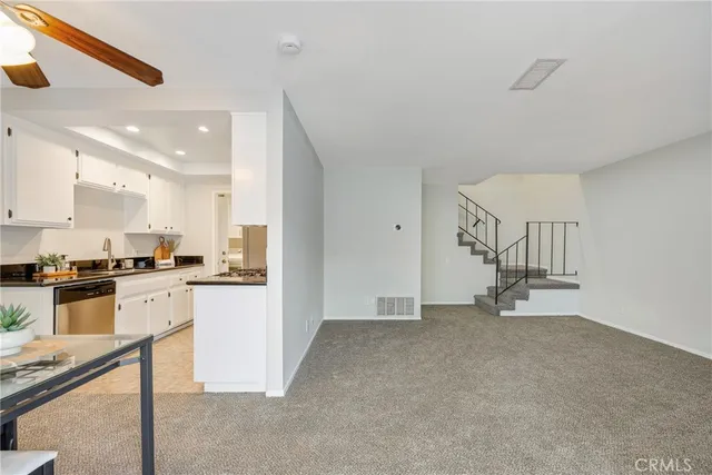 a view of a livingroom with furniture and a fan