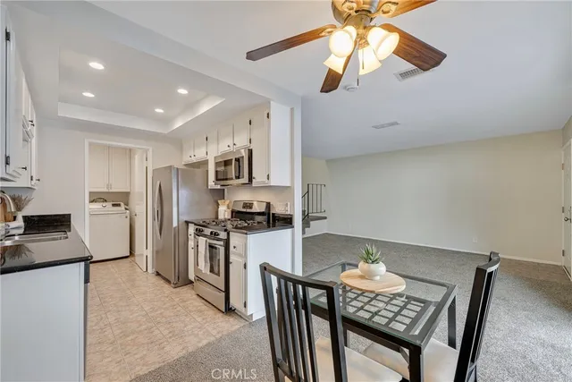 a kitchen with stainless steel appliances a stove a sink and a refrigerator