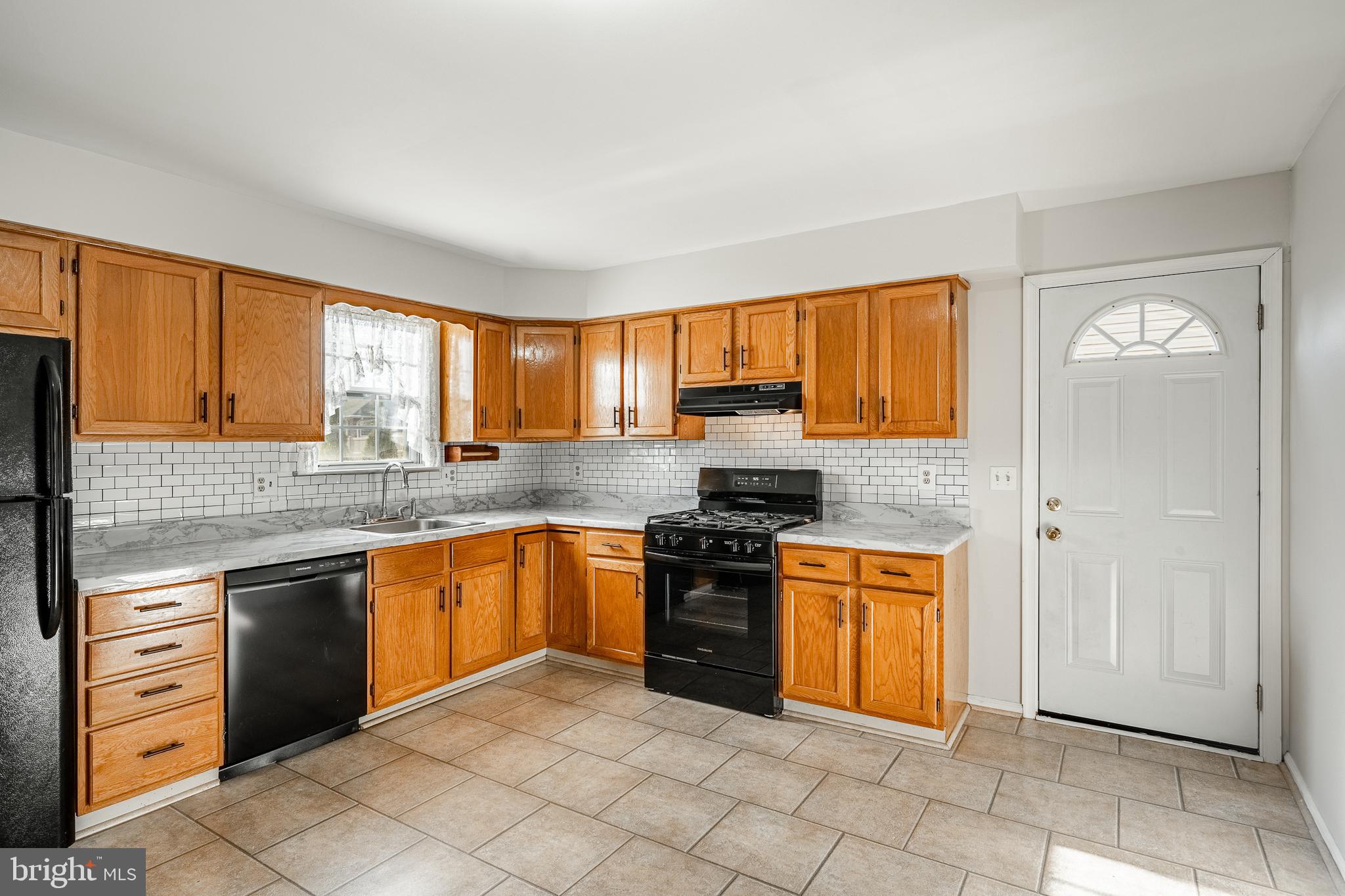 421 East Eagle Road Havertown, PA 19083 - Photo 11 of 49 a kitchen with stainless steel appliances granite countertop a stove sink and cabinets