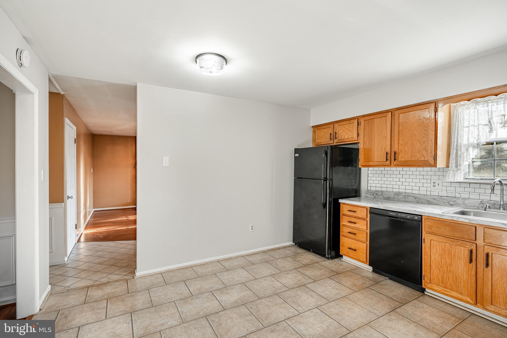 421 East Eagle Road Havertown, PA 19083 - Photo 12 of 49 a kitchen with stainless steel appliances granite countertop a refrigerator and a sink