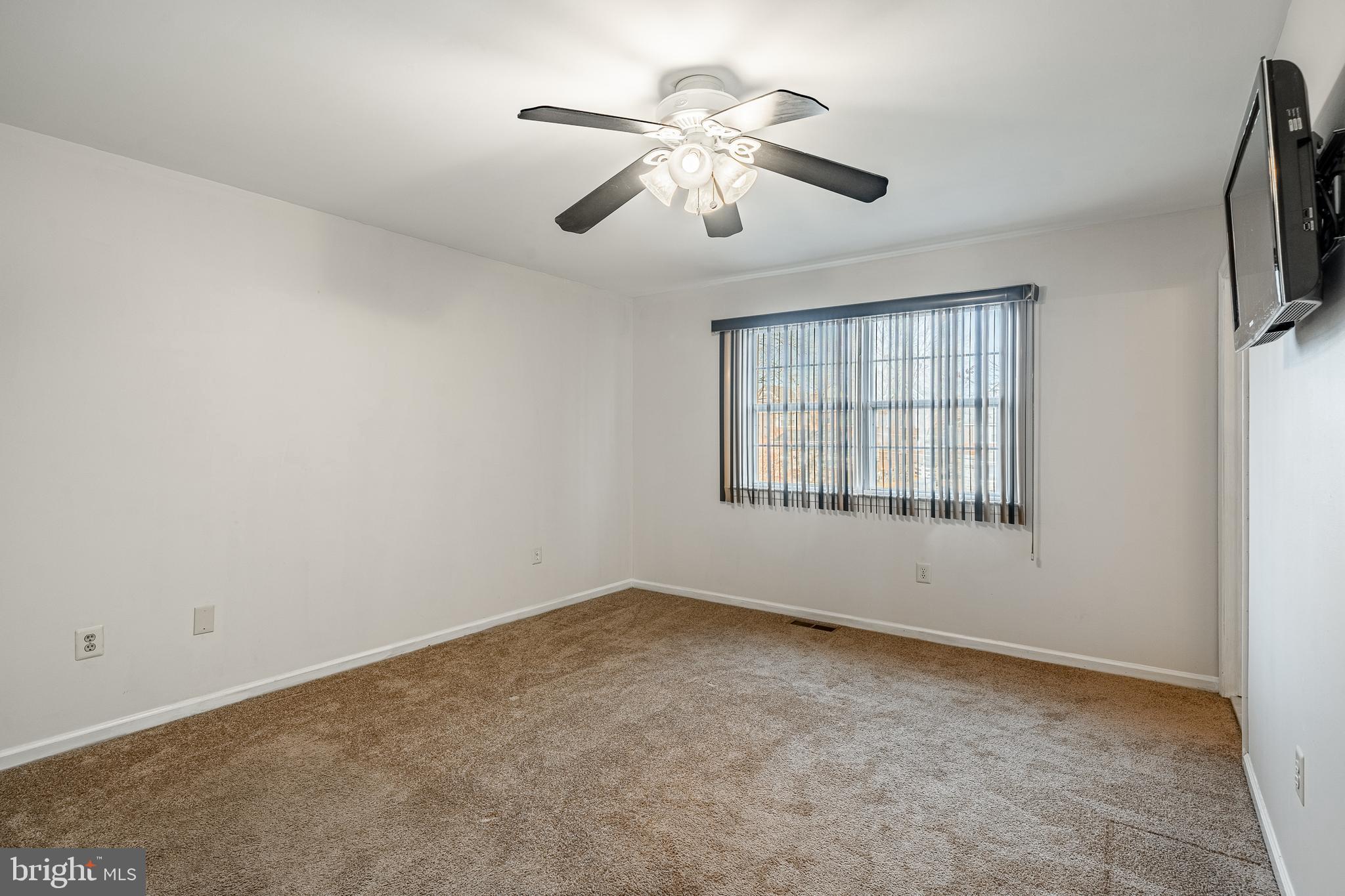 421 East Eagle Road Havertown, PA 19083 - Photo 17 of 49 an empty room with chandelier fan and windows