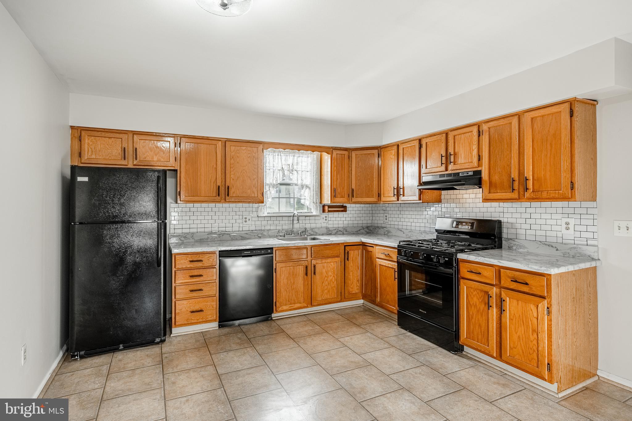 421 East Eagle Road Havertown, PA 19083 - Photo 10 of 49 a kitchen with stainless steel appliances granite countertop a refrigerator stove top oven and sink