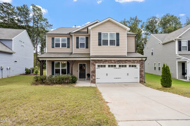 a front view of a house with yard