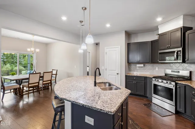 a kitchen with granite countertop kitchen island cabinets stainless steel appliances and a counter top space