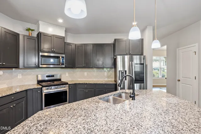 a kitchen with center island table and chairs in it