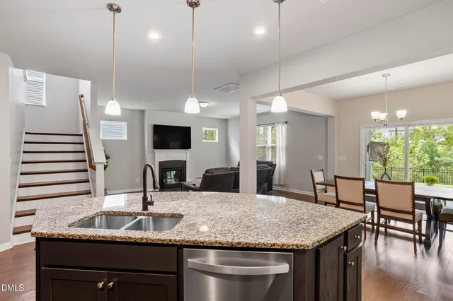 a kitchen with granite countertop cabinets stainless steel appliances and wooden floor