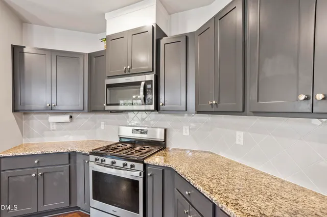 a dining room with furniture a chandelier and wooden floor